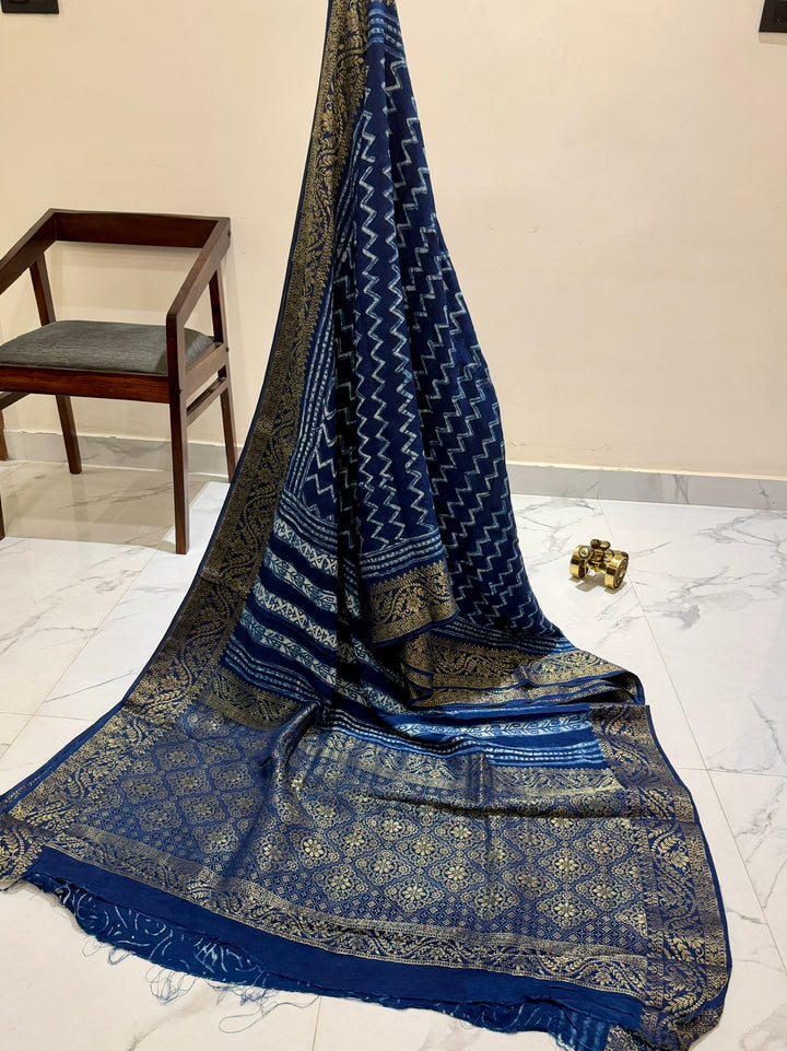 Premium Indigo Blue Dola Silk Saree with Traditional Handblock Zig-Zag Prints and Golden Zari Border.